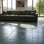 Modern living room with polished Kota stone flooring in grey and green shades